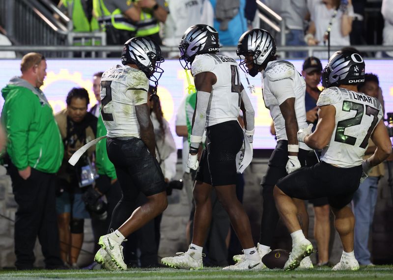 Sep 27, 2025; University Park, Pennsylvania, USA; Oregon Ducks wide receiver Gary Bryant Jr. (2), wide receiver Malik Benson (4) react after a touchdown during overtime against the Penn State Nittany Lions at Beaver Stadium. Mandatory Credit: Matthew O'Haren-Imagn Images