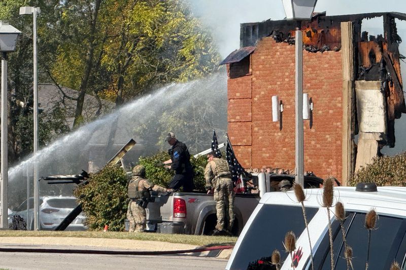 A silver truck is seen outside of the Church of Jesus Christ of Latter-day Saints as local authorities work to contain a fire on Sunday, Sept. 28, 2025.