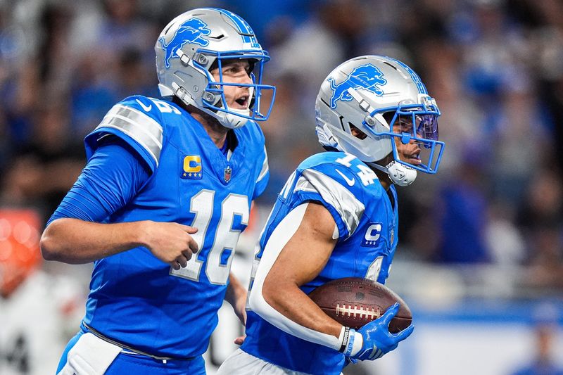 Detroit Lions wide receiver Amon-Ra St. Brown (14) celebrates a touchdown against Cleveland Browns with quarterback Jared Goff (16) during the second half at Ford Field in Detroit on Sunday, Sept. 28, 2025.