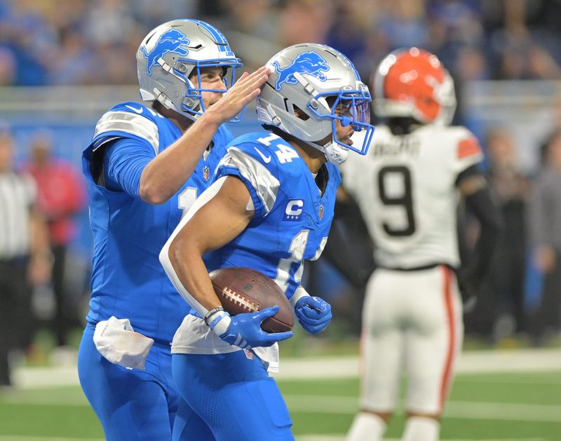 Lions quarterback Jared Goff (16) pats Lions wide receiver Amon-Ra St. Brown (14) on the helmet after they connect for a touchdown in the fourth quarter. Detroit Lions take on the Cleveland Browns at Ford Field in Detroit on Sunday, September 28, 2025. Lions win, 34-10.