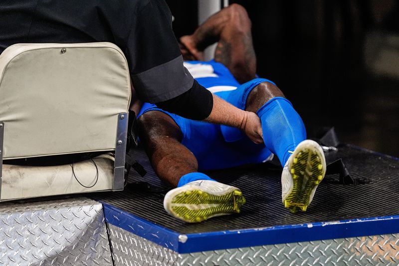 Detroit Lions cornerback D.J. Reed (4) is being taken off the field due to an injury during the second half against Cleveland Browns at Ford Field in Detroit on Sunday, Sept. 28, 2025.