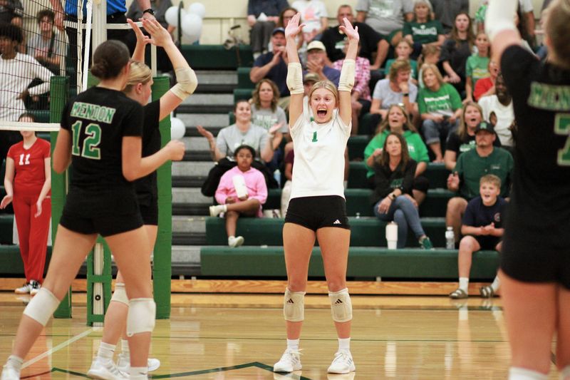 Jadyn Samson celebrates a point with her teammates against Battle Creek St. Philip on Tuesday.