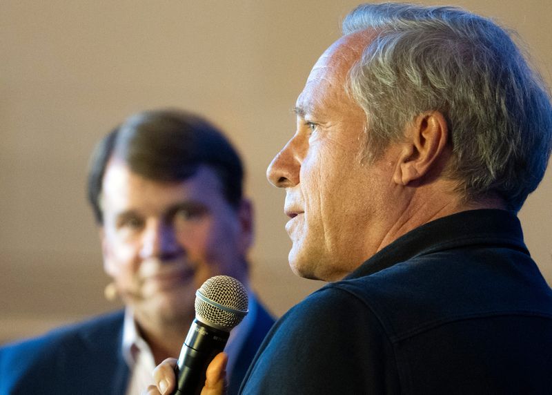 From left, Ford CEO Jim Farley listens as Mike Rowe speaks during the Ford Pro Accelerate, Tuesday, Sept. 30, 2025, at Michigan Central in Detroit.
