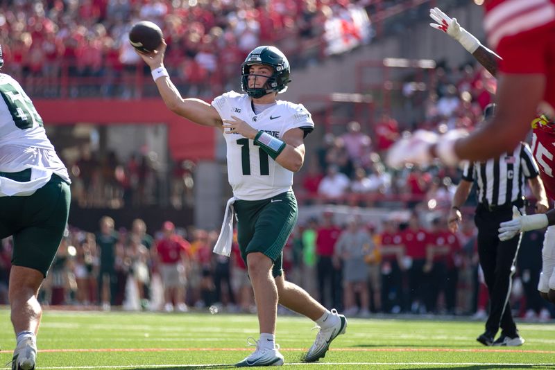 Oct 4, 2025; Lincoln, Nebraska, USA; Michigan State Spartans quarterback Alessio Milivojevic (11) throws the ball during the first half of the game against Nebraska at Memorial Stadium. Mandatory Credit: Kylie Graham-Imagn Images