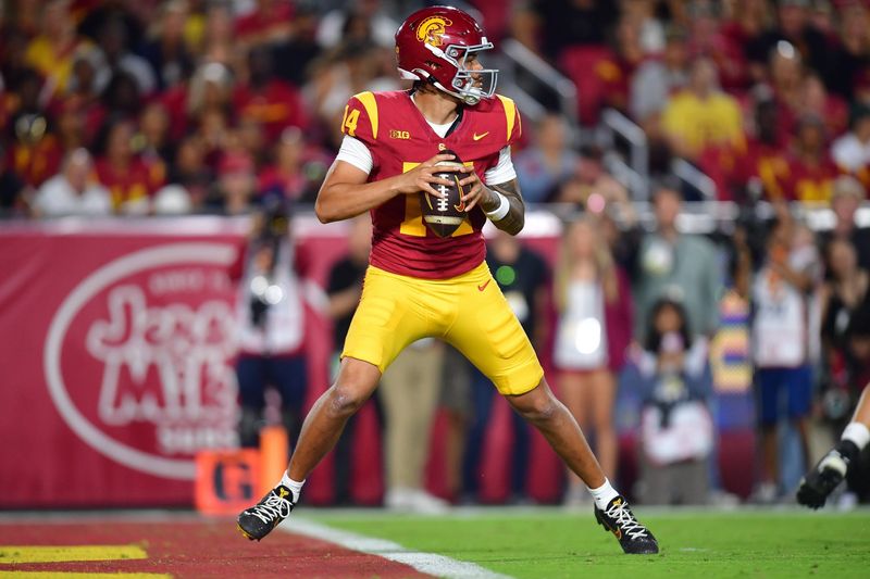 Sep 20, 2025; Los Angeles, California, USA; Southern California Trojans quarterback Jayden Maiava (14) drops back to pass against the Michigan State Spartans during the first half at the Los Angeles Memorial Coliseum. Mandatory Credit: Gary A. Vasquez-Imagn Images