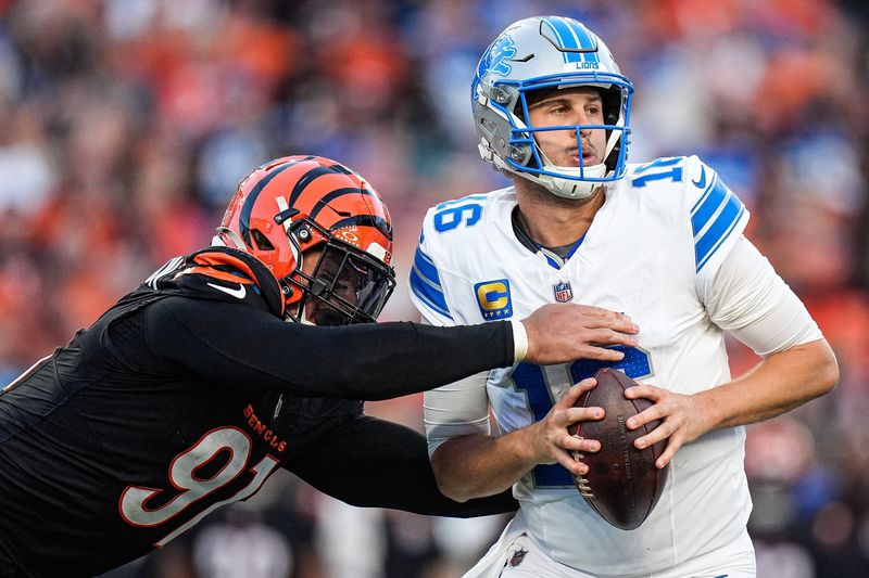 Detroit Lions quarterback Jared Goff (16) is sacked by Cincinnati Bengals defensive end Trey Hendrickson (91) during the second half at Paycor Stadium in Cincinnati on Sunday, Oct. 5, 2025.