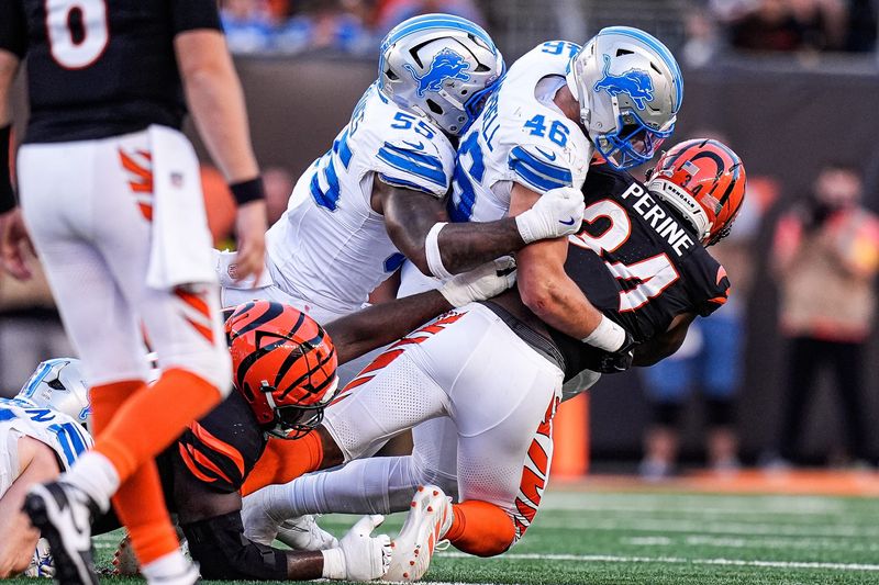 Detroit Lions linebacker Jack Campbell (46) and linebacker Derrick Barnes (55) tackle Cincinnati Bengals running back Samaje Perine (34) during the second half at Paycor Stadium in Cincinnati on Sunday, Oct. 5, 2025.
