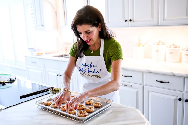 Maureen Abood prepares baklava pistachio nests for a future social media post in the kitchen of her home on Monday, Oct. 6, 2025, in East Lansing.