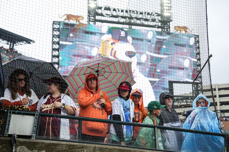 Baseball fans wait in stands due to rain delay at ALDS Game 3 between Detroit Tigers and Seattle Mariners at Comerica Park in Detroit on Tuesday, Oct. 7, 2025.