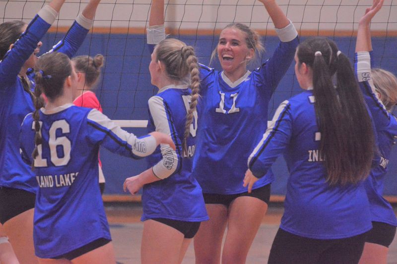 Inland Lakes volleyball players celebrate a point during the third set of a match against Onaway in Indian River on Tuesday, Oct. 7.