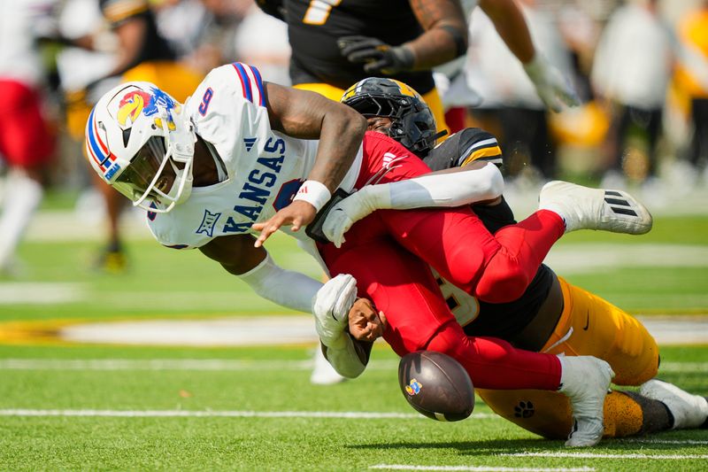 Sep 6, 2025; Columbia, Missouri, USA; Kansas Jayhawks quarterback Jalon Daniels (6) fumbles as he is tackled by Missouri Tigers defensive end Zion Young (9) during the first half at Faurot Field at Memorial Stadium. Mandatory Credit: Jay Biggerstaff-Imagn Images