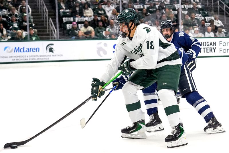 Michigan State's Ryker Lee moves the puck against New Hampshire during the first period on Thursday, Oct. 9, 2025, at Munn Ice Arena in East Lansing.