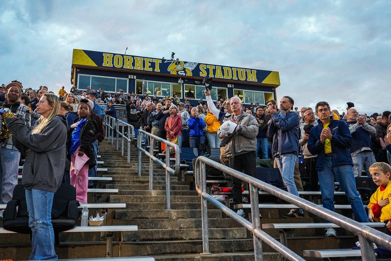 Fans cheer before a game between Saline and Harper Woods at Saline High School in Saline on Friday, Oct. 10, 2025.