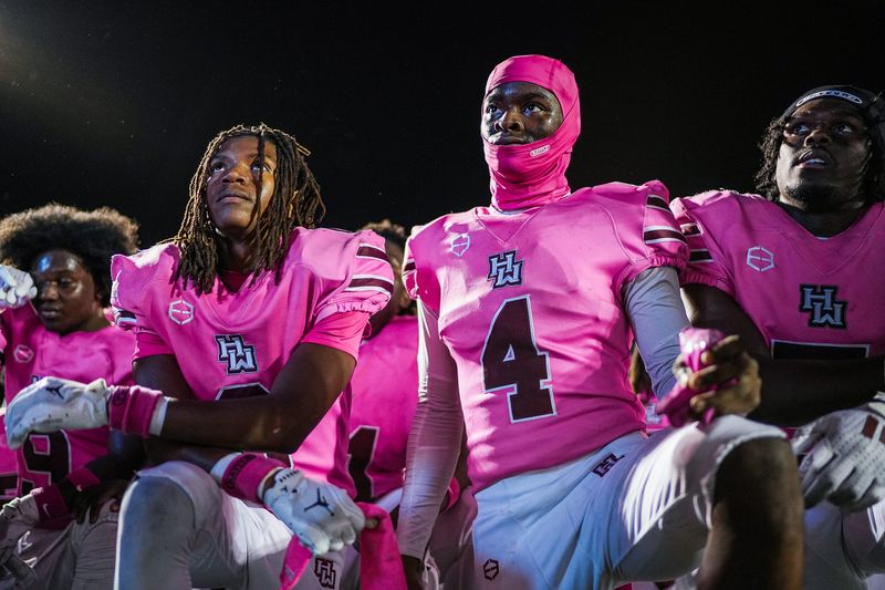 Harper Woods sophomore wide receiver Deandre Bidden (4) listens to head coach Rod Oden speak after defeating Saline at Saline High School in Saline on Friday, Oct. 10, 2025. Harper Woods won 41-32.