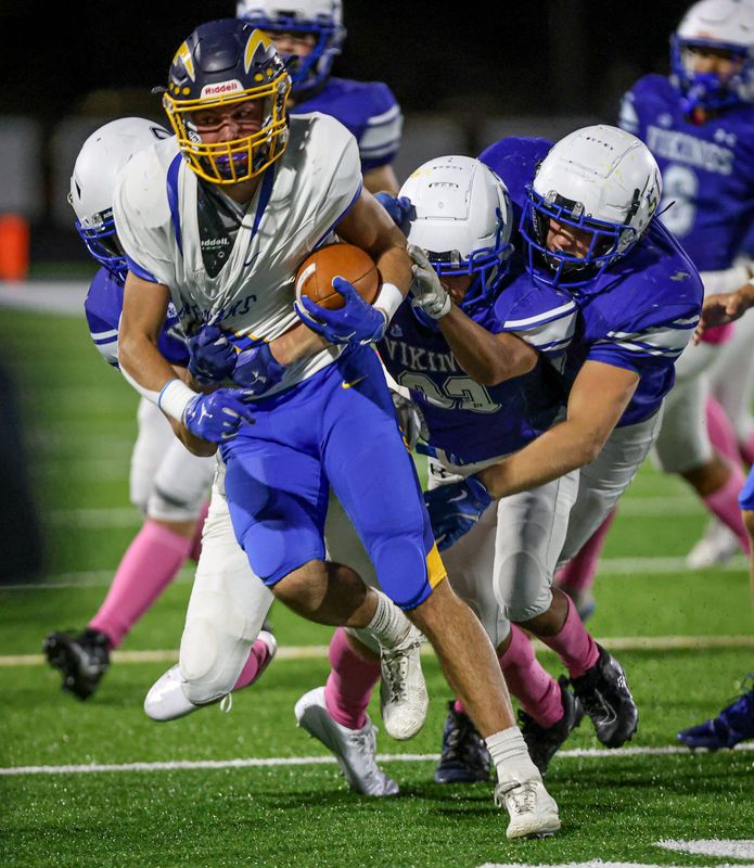 Ida's Gavin Albring fights for extra yards during a 63-38 win over Dundee on Friday, Oct. 10, 2025.