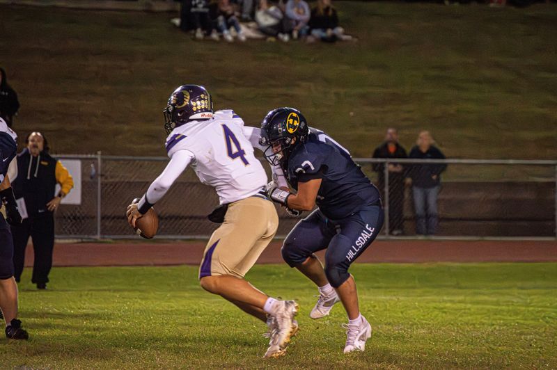 Hillsdale defensive lineman Nolan Francis (77) gets one of his two sacks against Onsted.