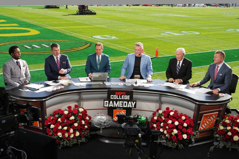 Jan 1, 2025; Pasadena, California, USA; From left: Desmond Howard, Rece Davis, Nick Saban, Pat McAfee, Lee Corso and Kirk Herbstreit on the ESPN Gameday set at Rose Bowl Stadium. Mandatory Credit: Kirby Lee-Imagn Images