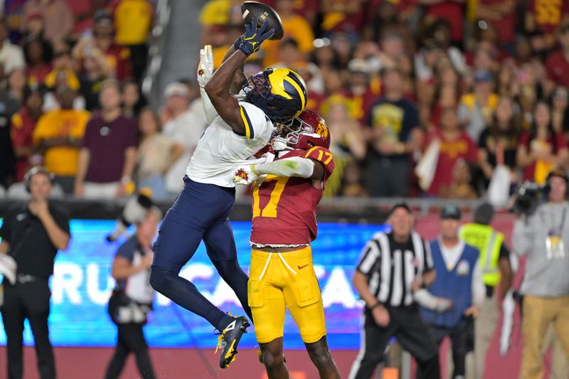 USC Trojans cornerback Decarlos Nicholson (17) breaks up a pass in the end zone for Michigan Wolverines wide receiver Andrew Marsh (4) in the second half at the Los Angeles Memorial Coliseum in Los Angeles on Saturday, Oct. 11, 2025.