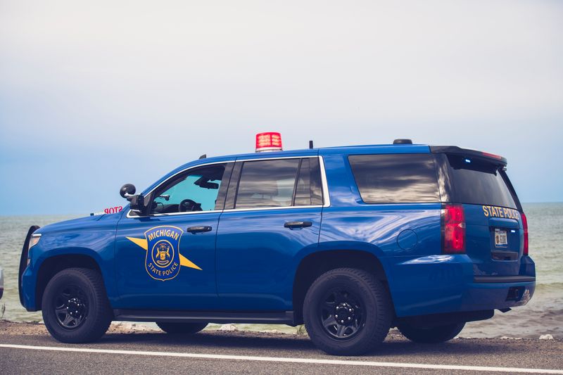 A Michigan State Police vehicle parked on a road's shoulder.
