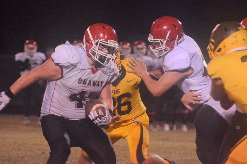 Onaway junior fullback Zach Schmoldt (45) looks for positive yardage during a football game at Pellston on Thursday, Oct. 16.