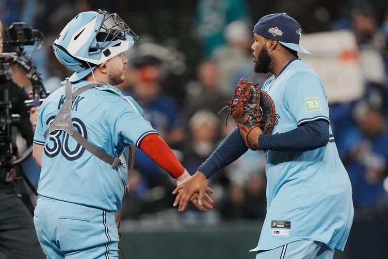 Toronto Blue Jays catcher Alejandro Kirk (30) and first baseman Vladimir Guerrero Jr. (27) celebrate after defeating the Seattle Mariners in Game 4.