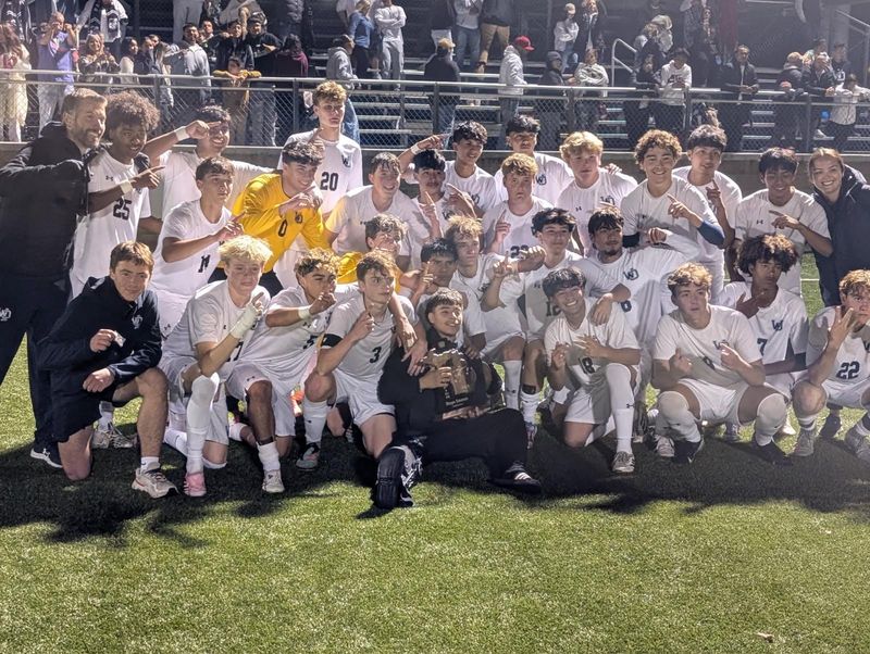 The West Ottawa boys soccer team celebrates its first district championship since 2010 on Thursday, Oct. 17, 2025, at Grand Haven High School.