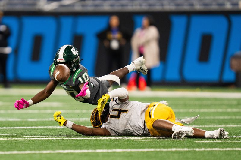 Detroit Cass Tech freshman wide receiver Peyton Robinson (10) jumps for a catch against Detroit King junior linebacker Don Spillers (4) during the second half at Detroit Public Schools Football League City Championships at Ford Field in Detroit on Friday, Oct. 17, 2025. Cass Tech won 35-19.