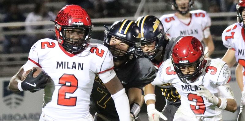 Milan's JJ Woods is chased by Patrick Murphy during a 33-27 Airport victory on Friday, Oct. 17, 2025.
