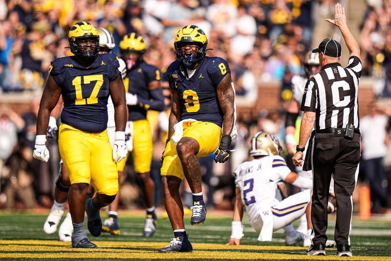 Michigan edge Derrick Moore (8) celebrates a sack against Washington quarterback Demond Williams Jr. (2) during the first half at Michigan Stadium in Ann Arbor on Saturday, Oct. 18, 2025.