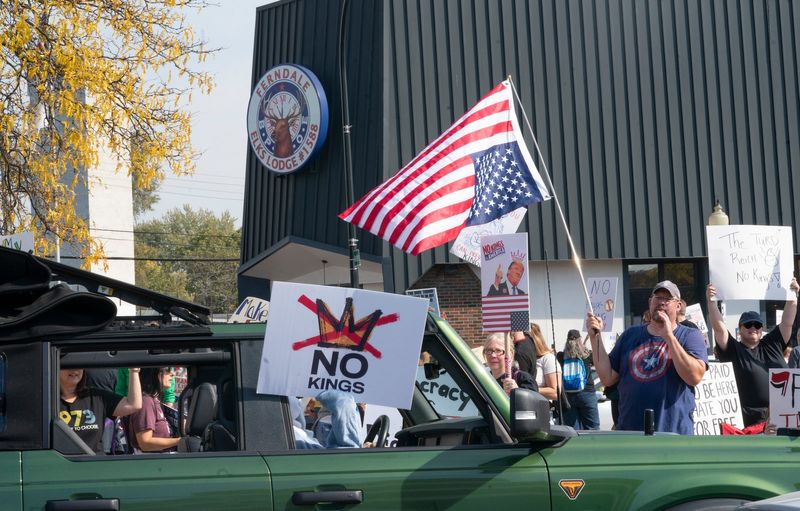 Protesters gather at Nine Mile and Woodward in Ferndale for the No Kings protest on Saturday, Oct. 18, 2025.