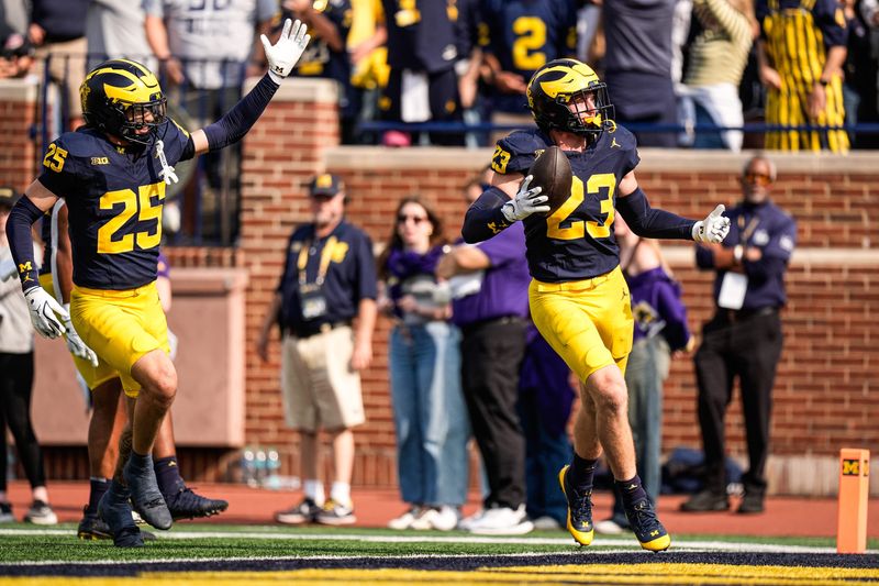 Michigan linebacker Cole Sullivan (23) celebrates an interception against Washington during the second half at Michigan Stadium in Ann Arbor on Saturday, Oct. 18, 2025.