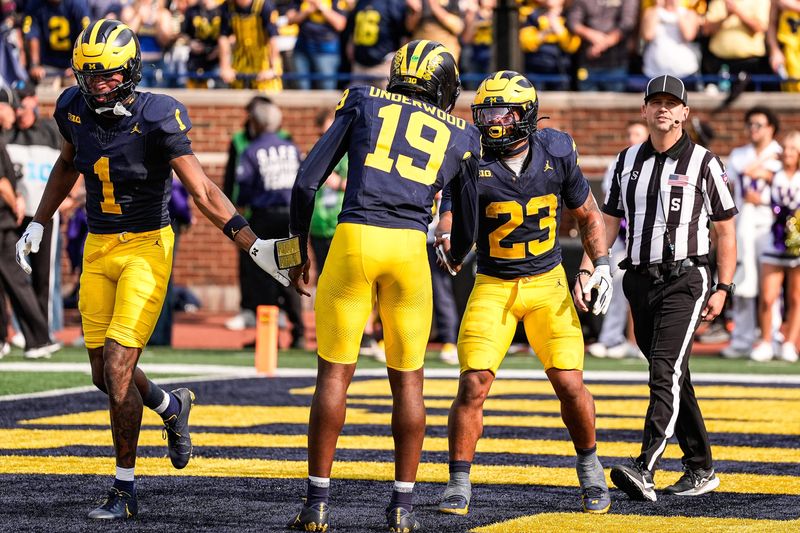 Michigan running back Jordan Marshall (23) celebrates a touchdown against Washington with quarterback Bryce Underwood (19) during the second half at Michigan Stadium in Ann Arbor on Saturday, Oct. 18, 2025.