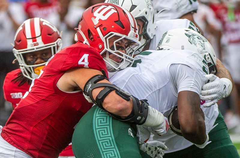 Indiana's Aiden Fisher (4) tackles Michigan State's Makhi Frazier (5) during the Indiana versus Michigan State football game at Memorial Stadium on Saturday, Oct. 18, 2025.