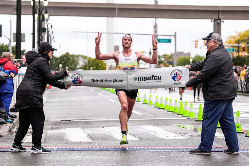 Andy Bowman of Ferndale crosses the finish line to win the male marathon race during the 48th annual Detroit Free Press Marathon presented by MSU Federal Credit Union in Detroit on Sunday, Oct. 19, 2025.