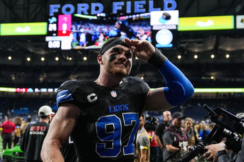 Detroit Lions defensive end Aidan Hutchinson (97) waves at fans after 24-9 win over Tampa Bay Buccaneers at Ford Field in Detroit on Monday, Oct. 20, 2025.