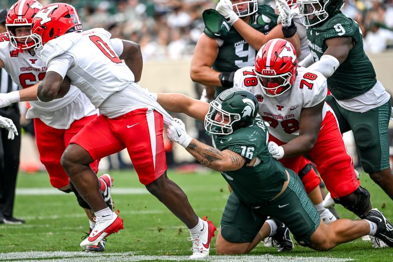 Michigan State's Grady Kelly, right, holds onto Youngstown State's Tahir Mills while making the tackle during the third quarter on Saturday, Sept. 13, 2025, at Spartan Stadium in East Lansing.