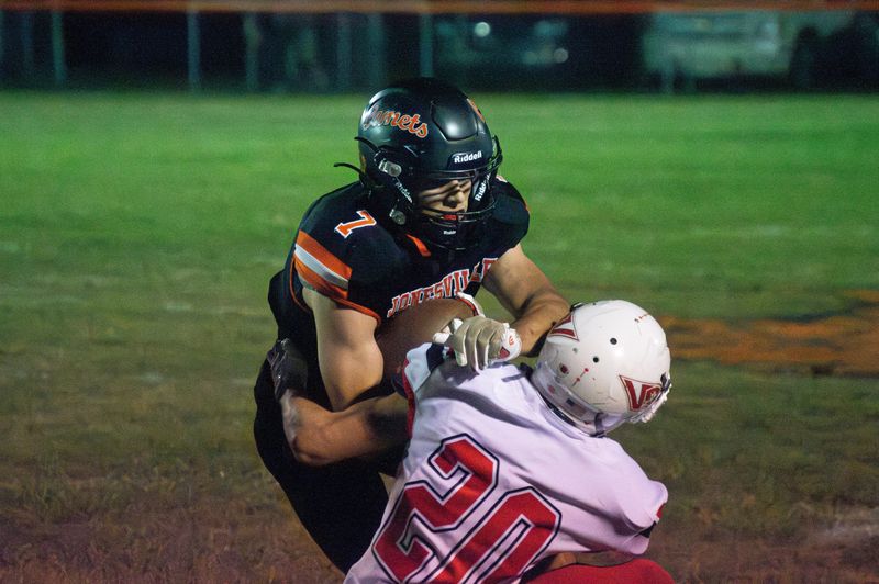 Junior running back John Milks runs over the Vandercook Lake defender.