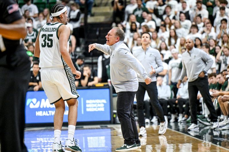 Michigan State's coach Tom Izzo, right, talks with Jesse McCulloch during the first half in the game against Bowling Green on Thursday, Oct. 23, 2025, at the Breslin Center in East Lansing.