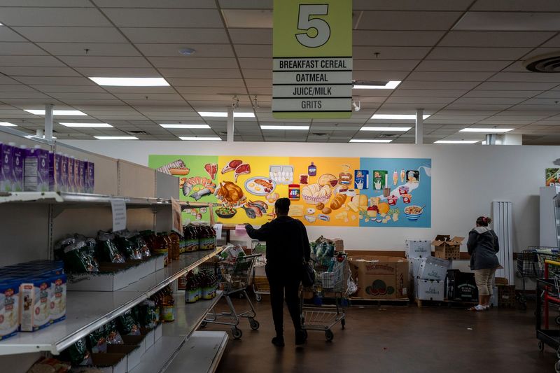 Detroit residents look for different food items inside Capuchin Soup Kitchen in Detroit on Friday, Oct. 24, 2025.