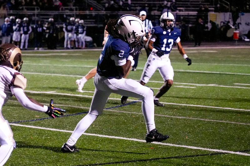 East Lansing's Jean-Micheal Smith intercepts a Holt pass during the second quarter on Friday, Oct. 24, 2025, at East Lansing High School.