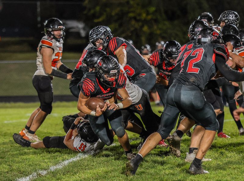 Clinton's Clifford Jones runs for tough yards versus Ubly on Friday as the offensive line grades the road
