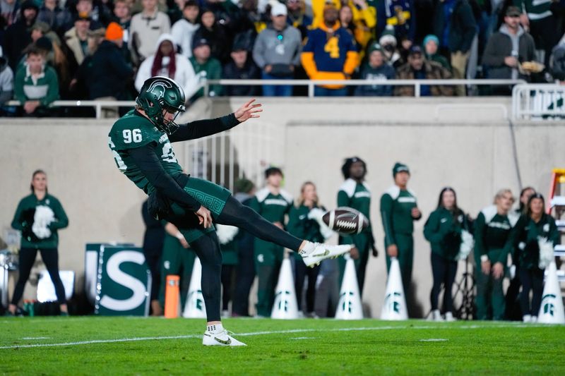 Oct 25, 2025; East Lansing, Michigan, USA; Michigan State Spartans punter Ryan Eckley (96) punts the ball against the Michigan Wolverines during the first half at Spartan Stadium. Mandatory Credit: Brendan Mullin-Imagn Images