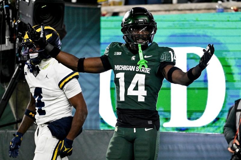 Michigan State's Malcolm Bell, right, reacts after getting called for pass interference against Michigan's Andrew Marsh during the first quarter on Saturday, Oct. 25, 2025, at Spartan Stadium in East Lansing.