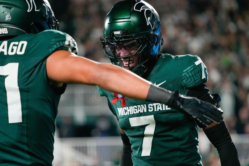 Oct 25, 2025; East Lansing, Michigan, USA; Michigan State Spartans cornerback Joshua Eaton (7) reacts after a defensive play against the Michigan Wolverines during the first half at Spartan Stadium. Mandatory Credit: Brendan Mullin-Imagn Images