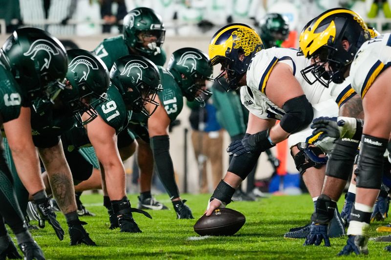 Oct 25, 2025; East Lansing, Michigan, USA; A view of the line of scrimmage during the first half of game between the Michigan State Spartans and the Michigan Wolverines at Spartan Stadium. Mandatory Credit: Brendan Mullin-Imagn Images
