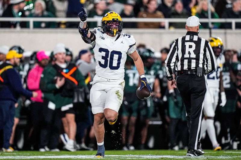Michigan linebacker Jimmy Rolder (30) celebrates a Michigan State turnover during the first half at Spartan Stadium in East Lansing on Saturday, October 25, 2025.