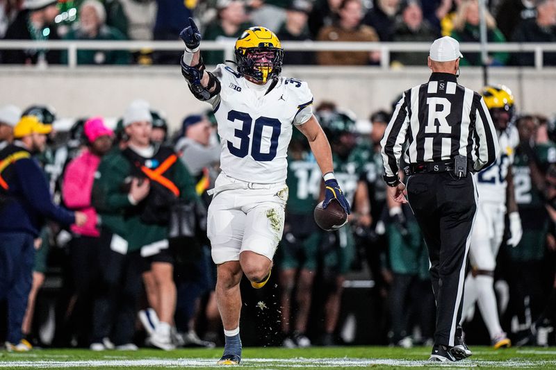 Michigan linebacker Jimmy Rolder (30) celebrates a Michigan State turnover during the first half at Spartan Stadium in East Lansing on Saturday, October 25, 2025.