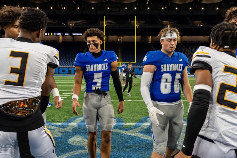 Detroit Catholic Central wide receiver Samson Gash (5) and teammate Hunter Stokes (86) shake hands with Detroit King players before the start of the 2025 Prep Bowl at Ford Field in Detroit on Saturday, Oct. 25, 2025.