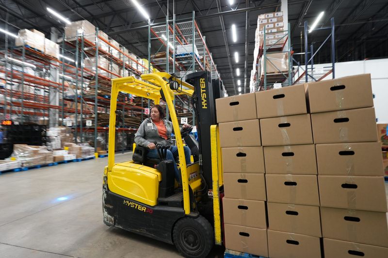 Phyllis Hanley of the Greater Lansing Food Bank moves boxes, Monday, Oct. 27, 2025, at the headquarters in Bath Township.