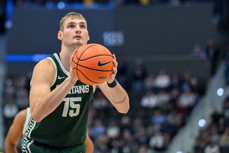 Oct 28, 2025; Hartford, CT, USA; Michigan State Spartans center Carson Cooper (15) shoots a free throw during the second half against the Connecticut Huskies at PeoplesBank Arena. Mandatory Credit: Mark Smith-Imagn Images